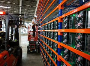 A Bitfarms employee installing Bitcoin mining rigs