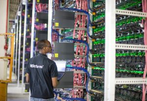 A Bitfarms employee inspecting Bitcoin mining hardware