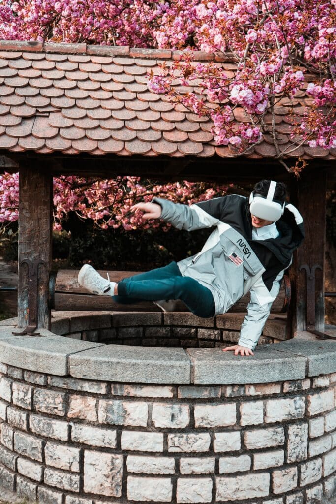 Boy wearing VR glasses jumping out of a water well. Photo by Alexis AMZ DA CRUZ at Unsplash