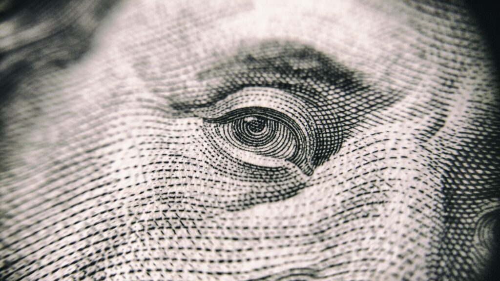 Focused view of Ben Franklin’s right eye from the US $100 bill. Photo courtesy of Vladislav Reshetnyak at Pexels. 